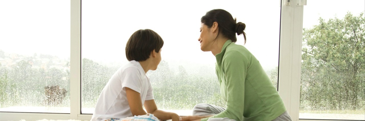 Telling My Kids I Have Cancer Side profile of young woman playing with son (8-9) on rug