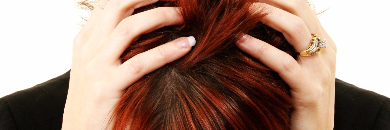 Responding to 'But You Don't Look Sick' as Person With Chronic Illness woman holding her head in frustration