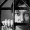 A woman behind bars