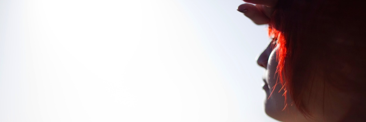 Feeling Like Something Was 'Wrong' With Me Before My Autism Diagnosis Woman with Hand on Forehead Peering Over Horizon