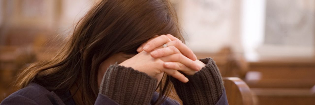 My Anxiety Doesn’t Make Me Less of a Christian sad Woman in Church