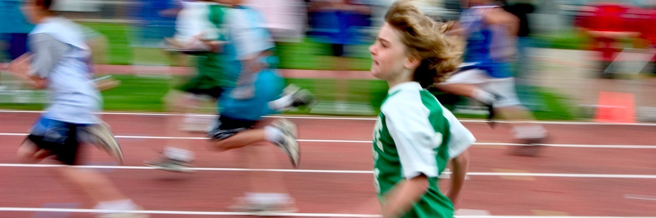 Young boy running on a track