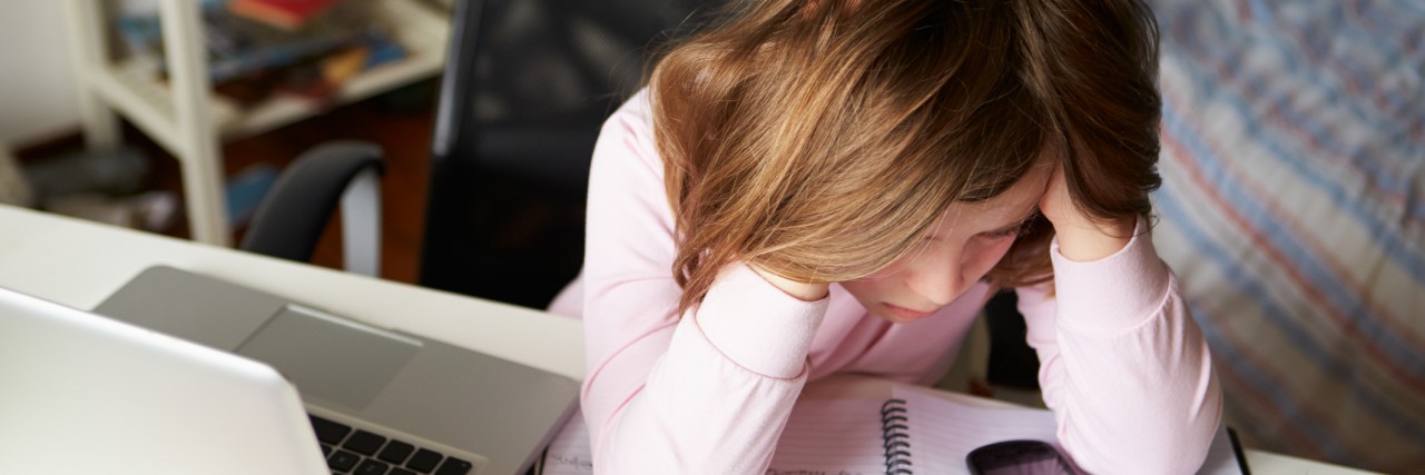 Letter to the Trump Administration From a Chronically Ill Teen Girl studying in her bedroom.