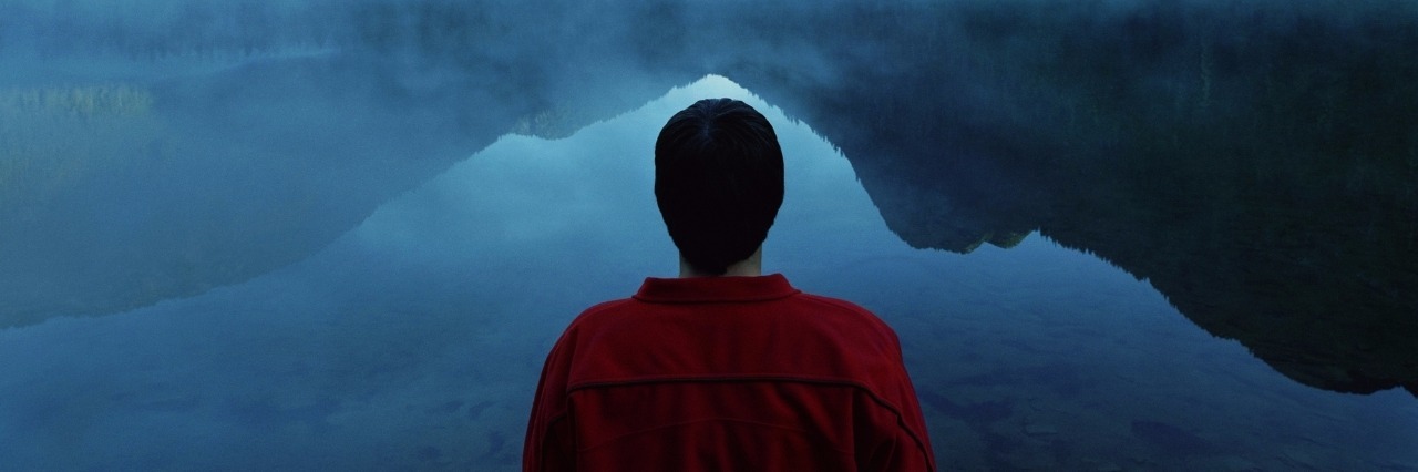 What It Means to Be a 'Quiet' Borderline Man standing by lake covered with fog, rear view