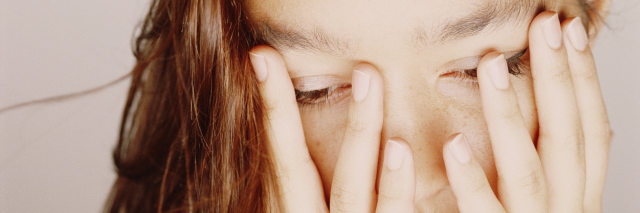 Autism: The Different Types of Meltdowns woman covering face with hands looking down