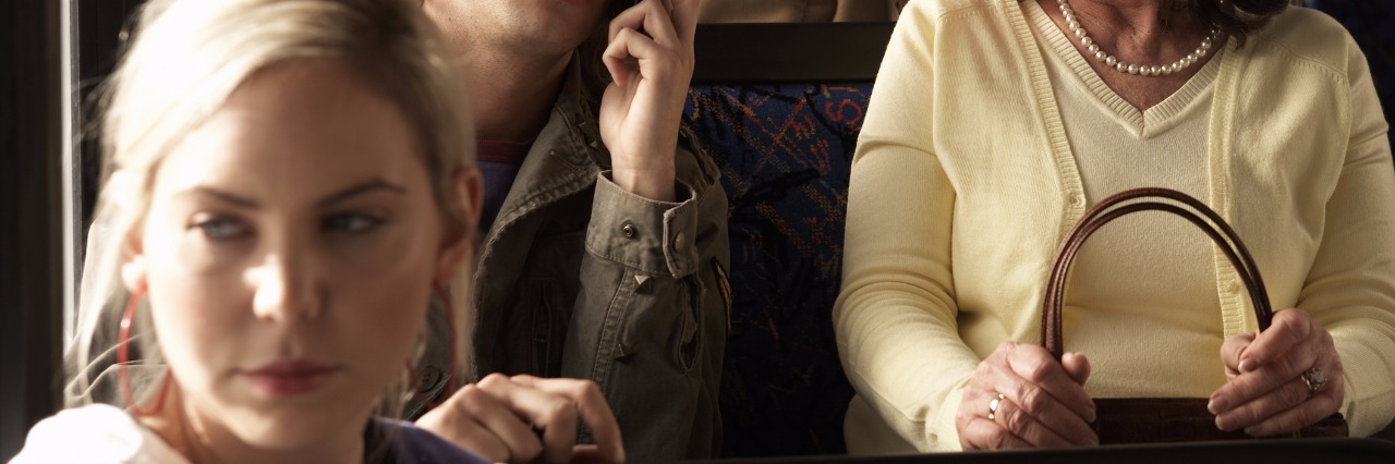 Having to Explain Invisible Disability to Strangers Young woman on bus.