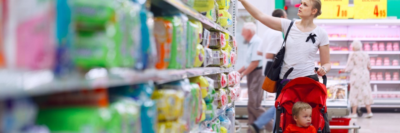 Tesco Launches Quiet Hour for Shoppers With Autism Mother with her boy in baby carriage in the supermarket