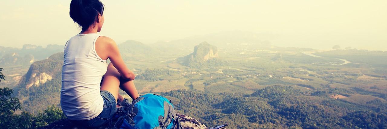 The Choice You Have to Make in Depression Recovery woman sitting after a mountain hike