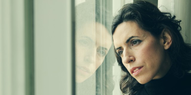 The Moment I Realized I Would Never 'Get Better' woman stands in front of the window