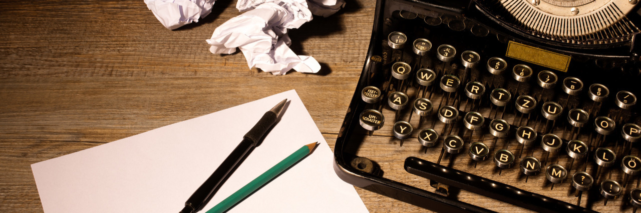 Vintage typewriter and a blank sheet of paper.