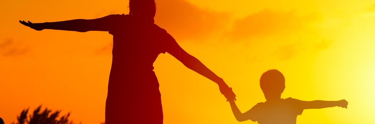 The Joys in My Life With My Son on the Autism Spectrum silhouette of mother and son walking together on beach at sunset