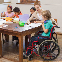 Child in a wheelchair in the classroom.