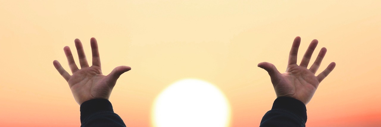 Getting a Bipolar Diagnosis Late in Life A man reaching his hand out in the sky