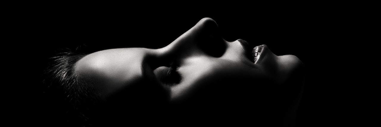 dark profile of a woman laying down