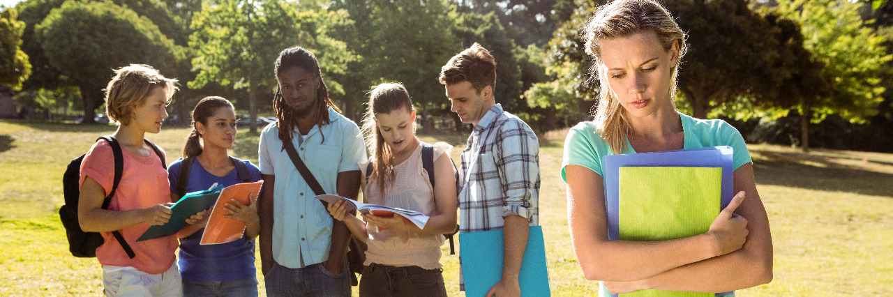 ADD/ADHD Is Not a Joke Young woman being bullied by a group of students.