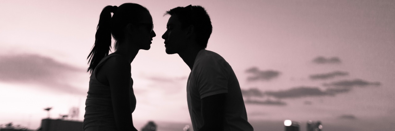 The Challenges of Dating With Crohn's Disease Romantic couple kissing in the city.