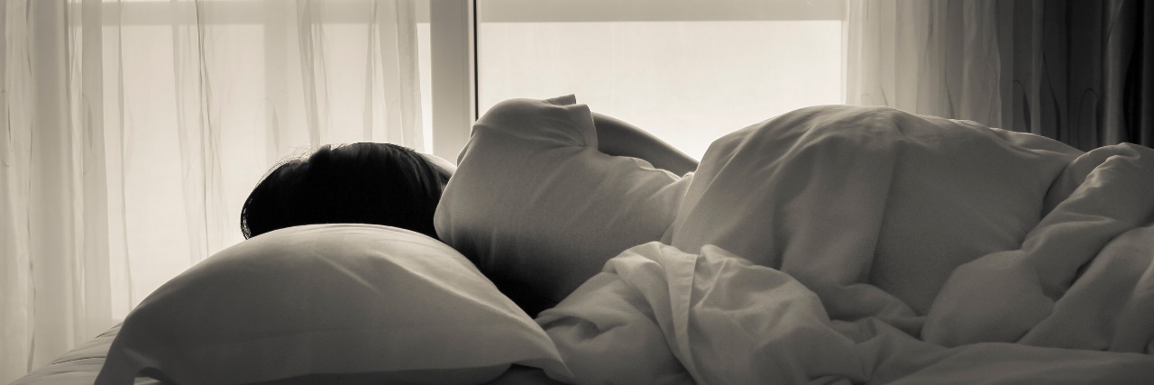 Dysautonomia: What Not to Say to Someone Chronically Ill on Bed Rest woman laying in bed and looking out the window