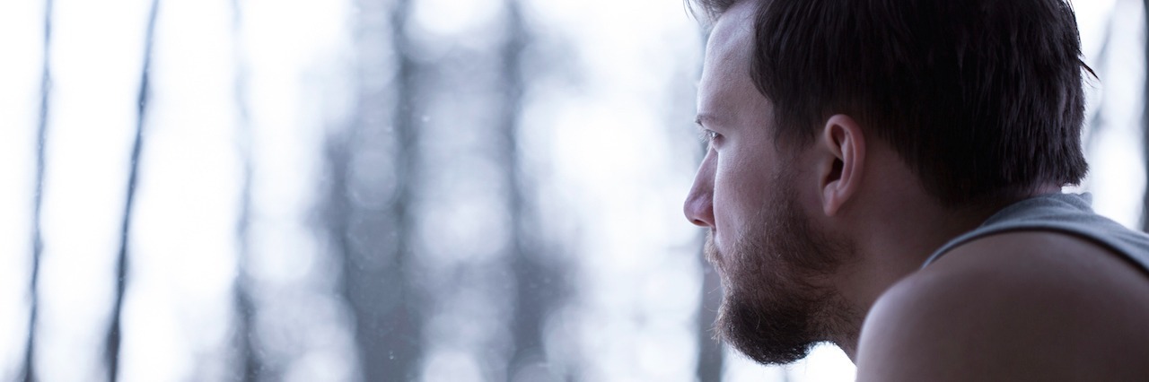 Understanding Depression: What to Know and How to Help A man looking out at the woods