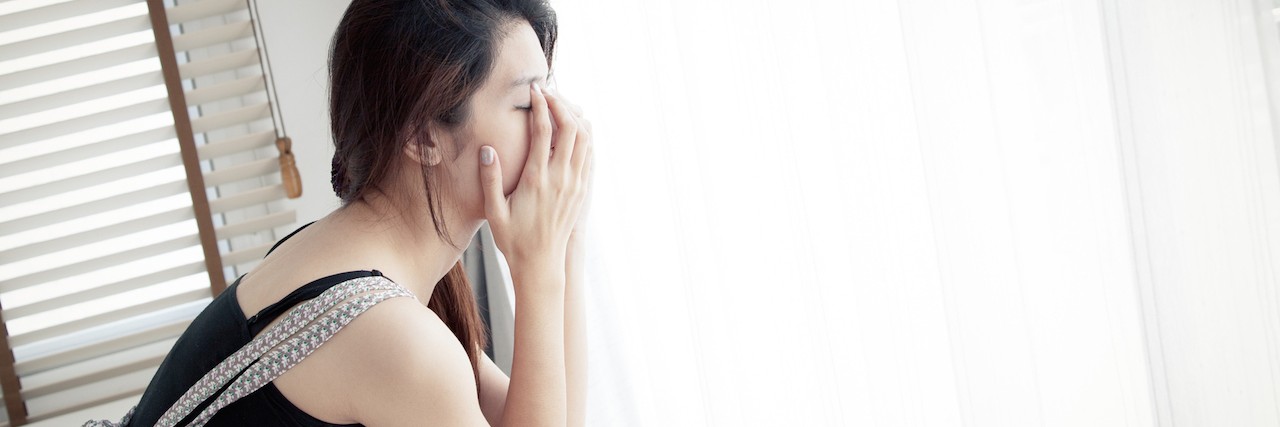 Things I Wish People Knew About My Eating Disorder A woman looking out the window