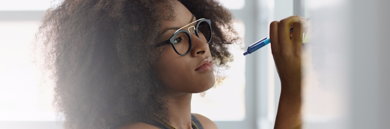 How I Wrote a Post on Facebook to Get a Job With Rheumatoid Arthritis Friendly executive business woman brainstorming using green adhesive notes in a modern white office