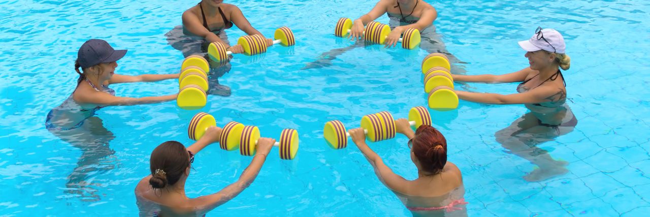 people doing exercise with aqua dumbbell in a swimming pool