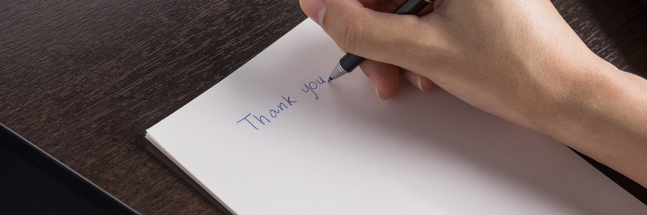 Why I Share My Mental Health Story A woman writing a thank you letter