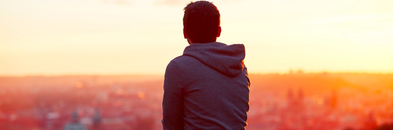 The Little Things That Are Hard to Deal With Multiple Sclerosis Young man is looking at the sunrise