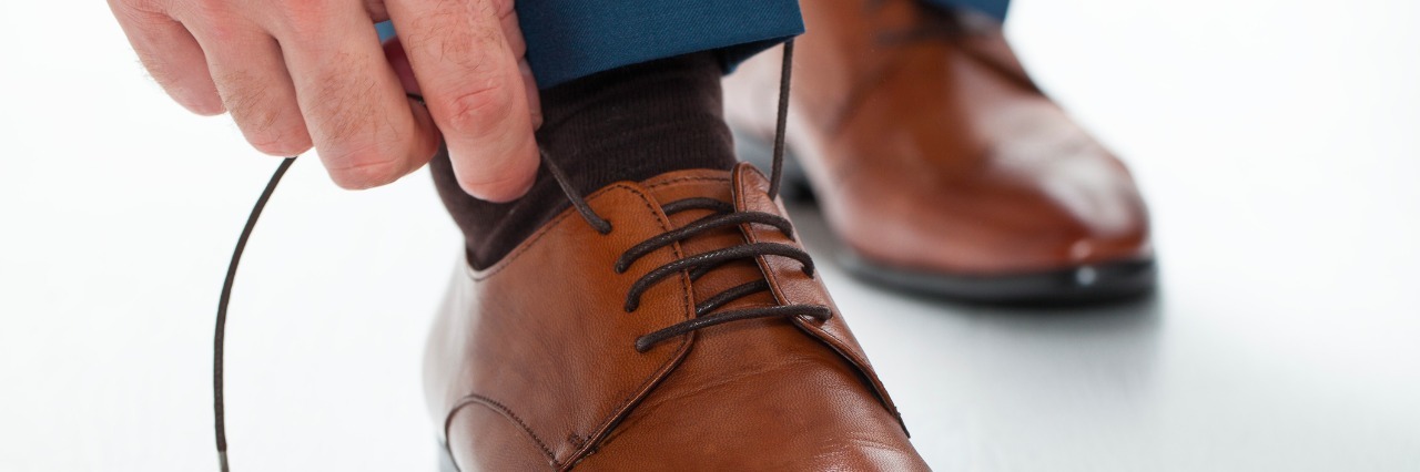 man tying his shoes