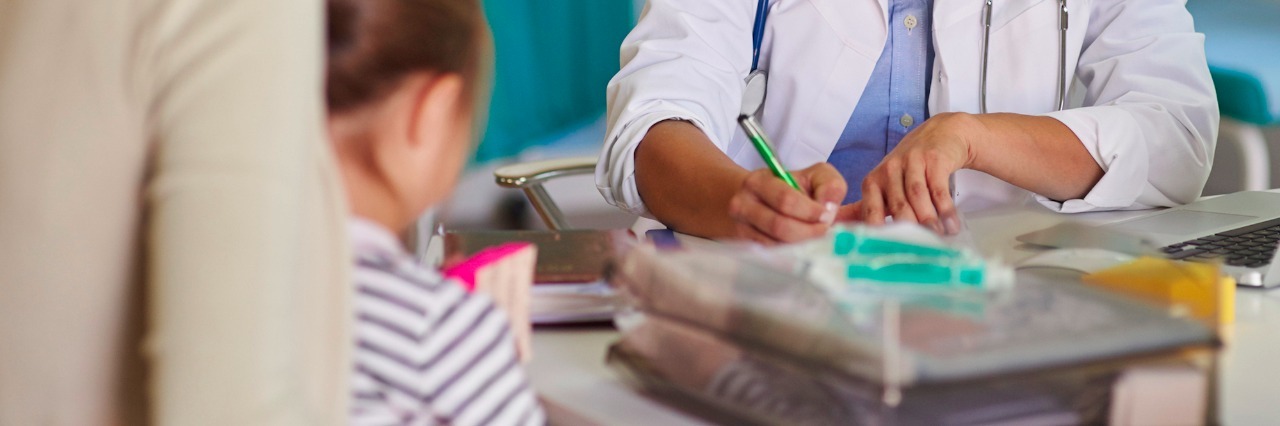 Mom Shares Story About Misdiagnosis in Congenital Heart Disease Doctor having meeting with parent and child in doctor's office