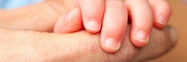 Close-up of parenting holding baby's hand