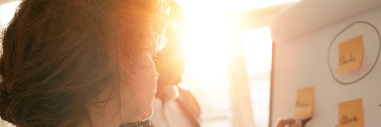 Anxiety and Dealing With a Co-Worker's Death Business associates putting their ideas on flipchart