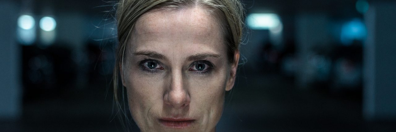 Depression and Self-Doubt Night portrait of an intense middle-aged blond woman