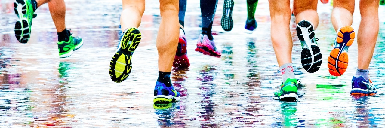 My Life With Illness Is Like Running the Boston Marathon While Sick. But I'm Winning. people running in a marathon on a wetted surface