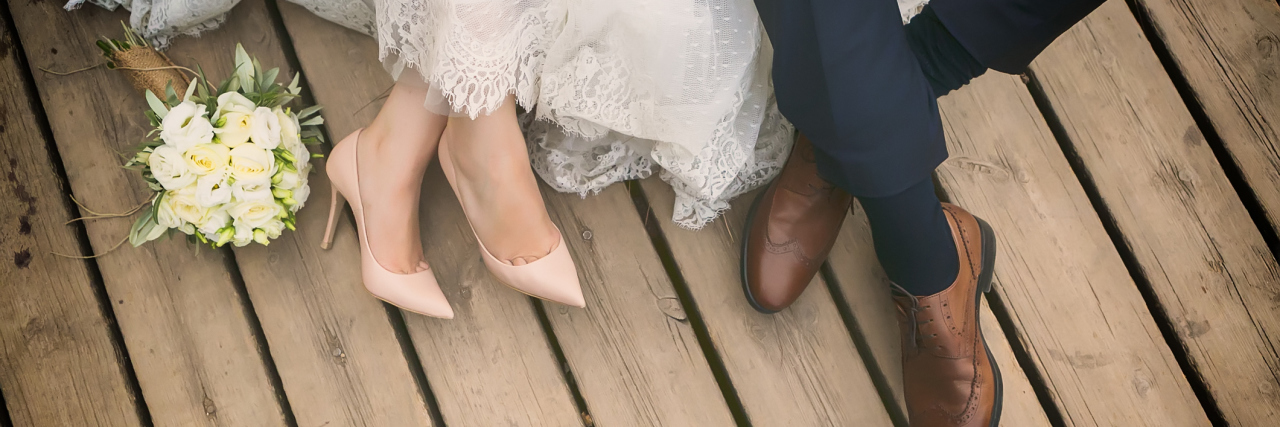Having a Chronically Ill Spouse: What to Know feet of bride and groom, wedding shoes (soft focus). Cross processed image for vintage lookfeet of bride and groom, wedding shoes (soft focus)