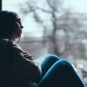 Teenage girl looking out the window