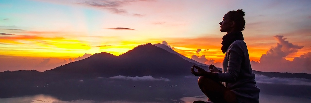 Anorexia and Self-Acceptance: You're Whole as You Are a woman meditates on the mountain