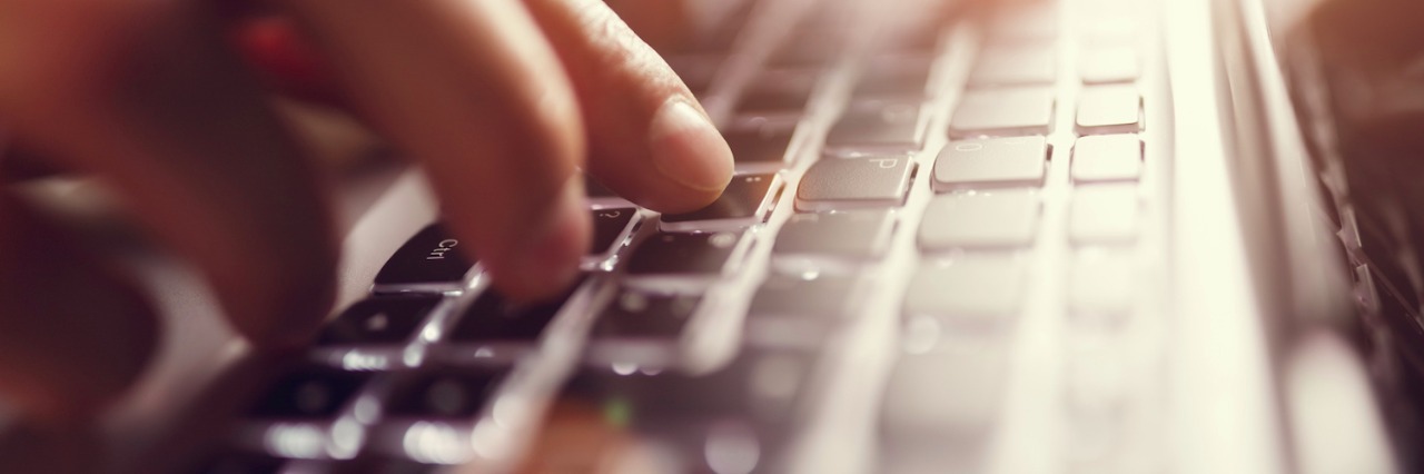 How My Daughter's Facebook Page Has Helped Me as a Mom and Advocate Hands typing on laptop computer