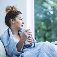 Young woman drinking coffee in bed