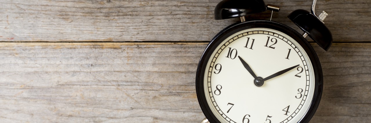 Anxiety Makes Getting Ready for Work a Long Process Retro alarm clock on wooden table