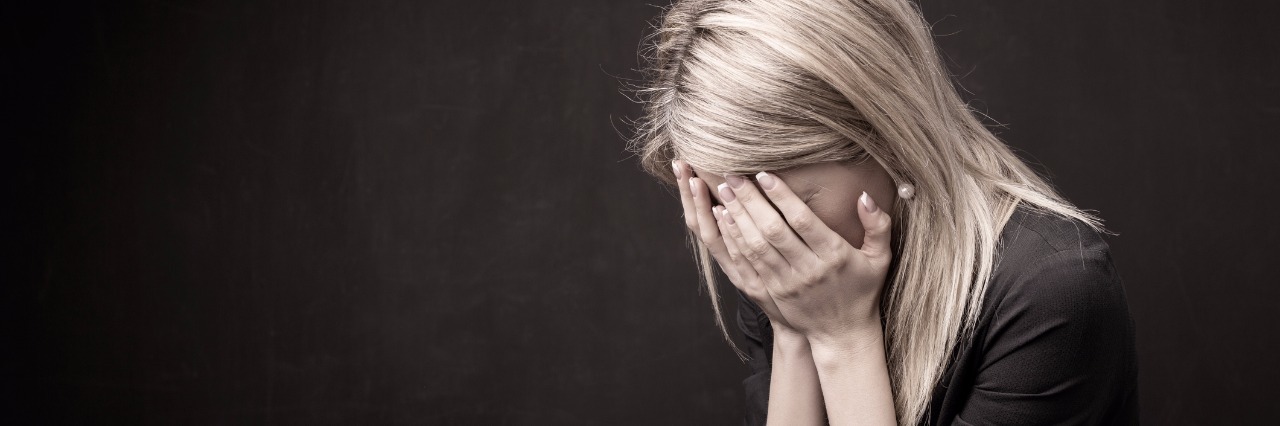 How I Deal With Feeling Angry Because of My Ehlers-Danlos Syndrome Woman holding her face in her hands