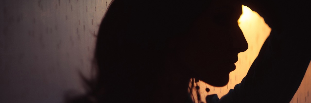 Tips for Improving Life With Myasthenia Gravis dark profile of a woman at sunset