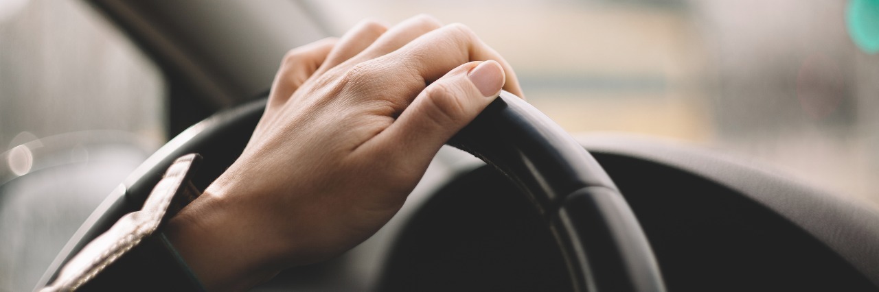 When You Feel Unable to Help in Your Child's Mental Illness Recovery close up of woman's hand driving car