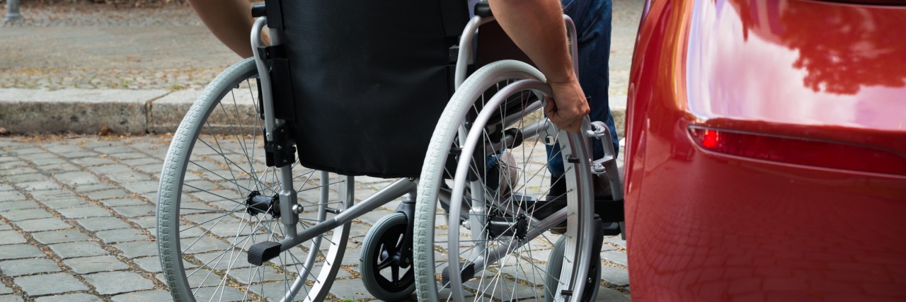 Responding to People Who Feel Awkward About My Wheelchair Man in a wheelchair near car.