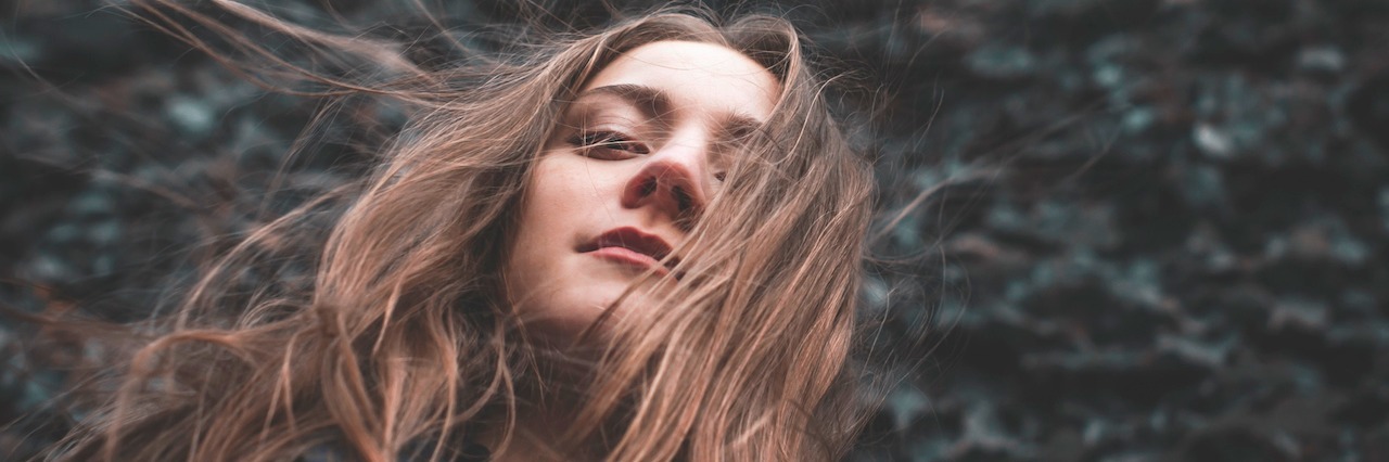 My Experience of Hallucinations and Psychosis in Bipolar Disorder A woman looking down