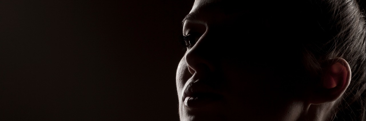 Postpartum Depression Makes It Hard to Ask for Help silhouette of a woman on a dark background