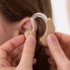 Girl getting a hearing aid.