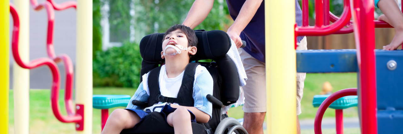 How to Make Playgrounds More Inclusive for Children With Disabilities Boy in wheelchair at the playground.