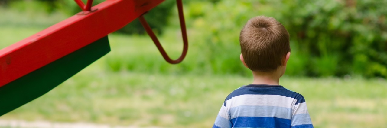 Little boy on the park playground in summer