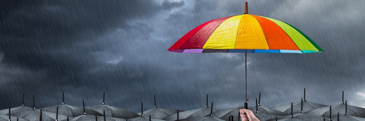 Why I'm 'Wrestling Blessings' Out of My Ehlers-Danlos Syndrome rainbow umbrella in mass of black umbrellas