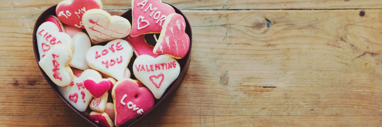Cookies in a box for Valentine's day on wooden table
